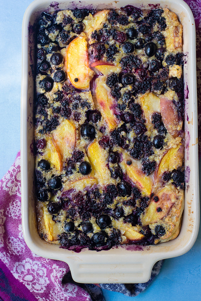 Blueberry and peach clafoutis is a French dessert where the fruit is baked in a creamy and light custard filling.