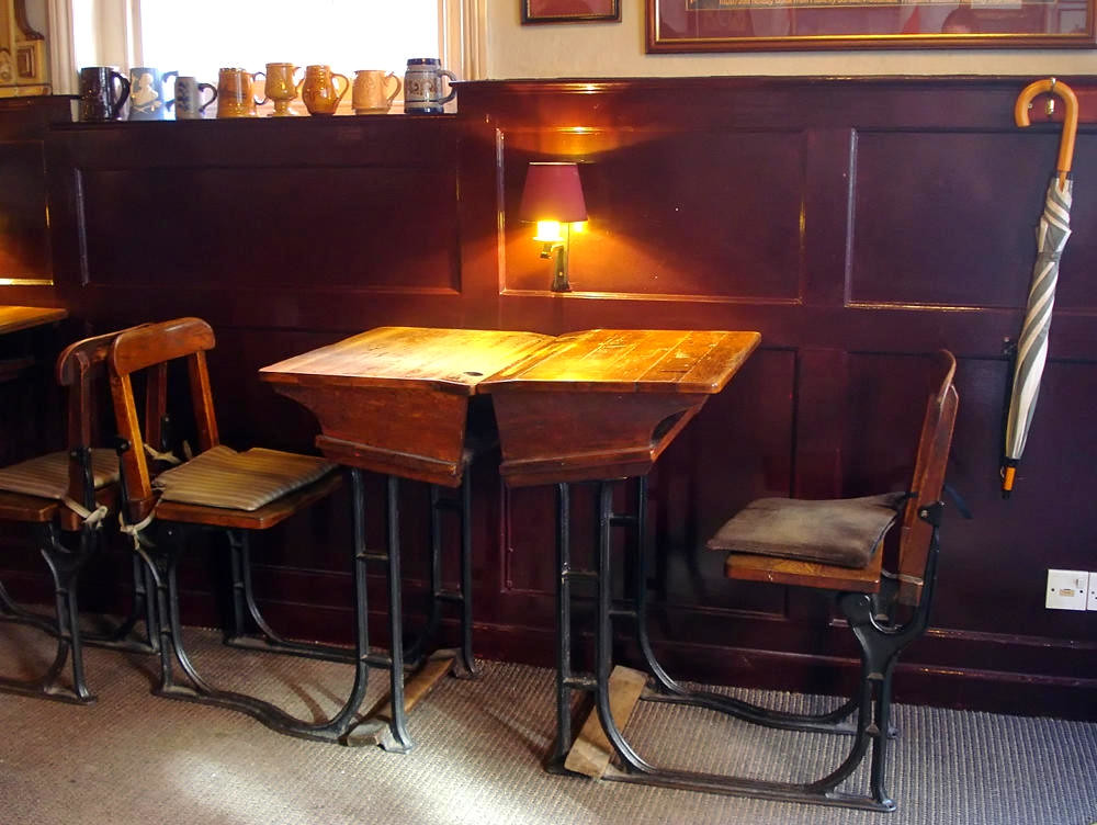 Inside the Wycham Arms pub with old school desks. Credit Kake, flickr