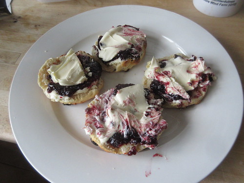 Fresh scones with butter, clotted cream and huckleberry jam