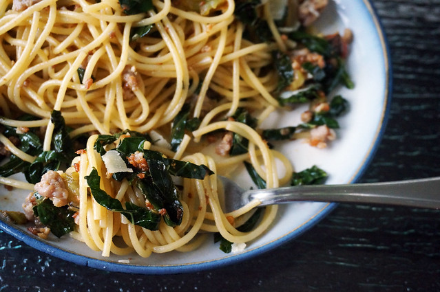 Closeup on a twirl of spaghetti with sausage and kale