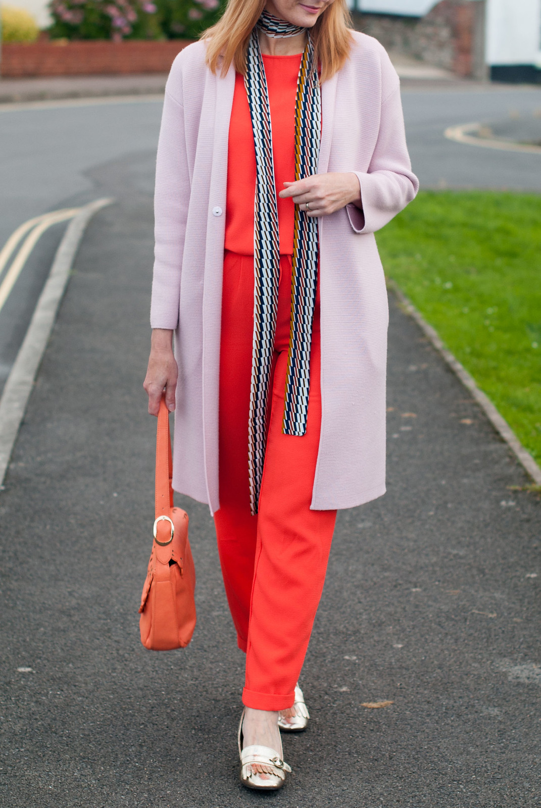 Ways to wear an orange jumpsuit: With a longline pink coatigan, metallic gold block heel loafers, 70s style skinny scarf | Not Dressed As Lamb, over 40 style