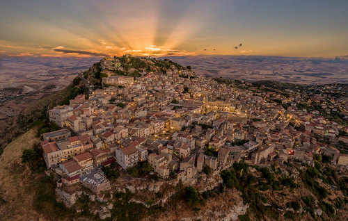 assoro sicily italy sunset landscape drone aerial panoramic high angle architecture mountains clouds skyline sunray old village