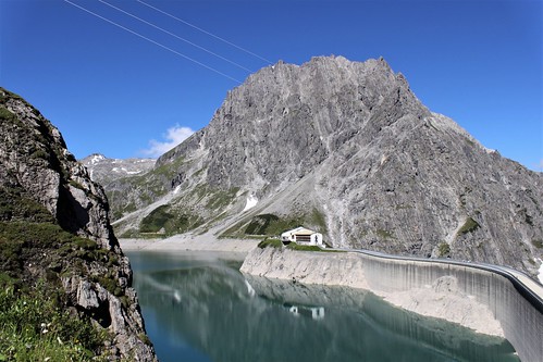 view of lake and dam with alps