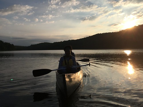 paddling canoeing canoers sunset reflections lake summer water