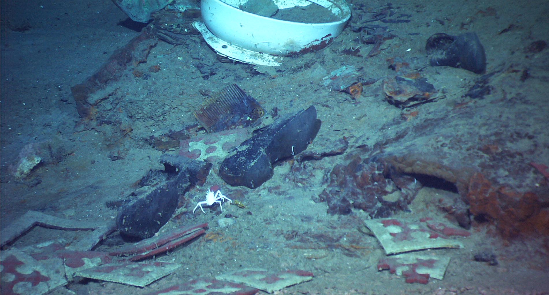 This photo provided by the Institute for Exploration, Center for Archaeological Oceanography/University of Rhode Island/NOAA Office of Ocean Exploration, shows The remains of a coat and boots, articulated in the mud on the sea bed near Titanic's stern, are suggestive evidence of where a victim of the disaster came to rest. (AP Photo/Institute for Exploration, Center for Archaeological Oceanography/University of Rhode Island/NOAA Office of Ocean Exploration) Photo taken April 14, 2012