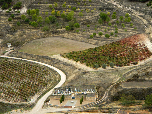 View of a cemetery and the vineyards beyond from the Castillo de Curiel, a renovated medieval castle that had been converted into a hotel near Penafiel in Spain