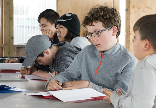 Campers take notes in a workbook provided to them this year. Students enrolled in the Kenai Peninsula Borough School District can receive school credit for camp attendance.