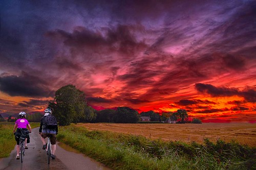 bicycle canonef24mmf14liiusm clouds cycling cyclists farmbuildings farmland lane road sky sunset trees