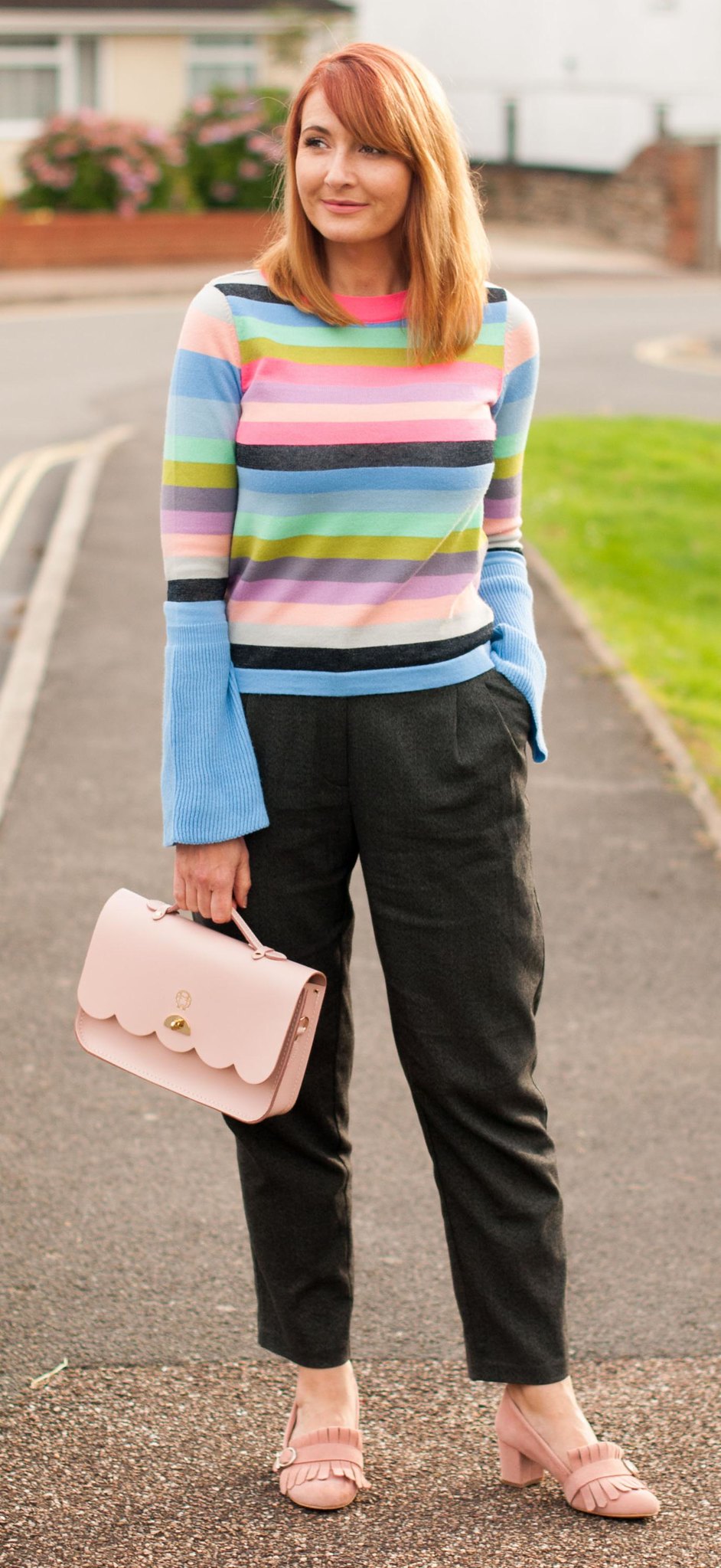 Bright autumnal outfit: Multi-coloured stripe sweater with fluted sleeves grey peg trousers pink suede block heel fringed shoes pink Cambridge Satchel Co Cloud satchel | Not Dressed As Lamb, over 40 style