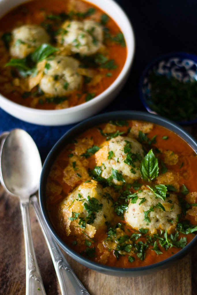 Roasted tomato soup with ricotta parmesan matzo balls is an Italian inspired twist for Passover matzo ball soup.