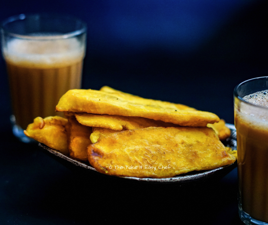 A plate of pazham pori with a glass of tea