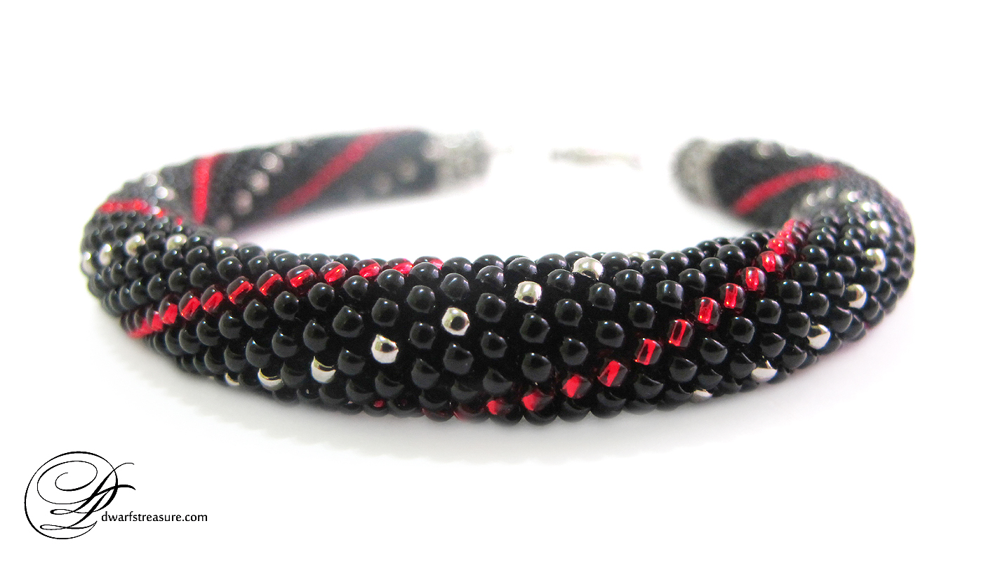 Boho Chic black beaded crochet bracelet with silver and red pattern