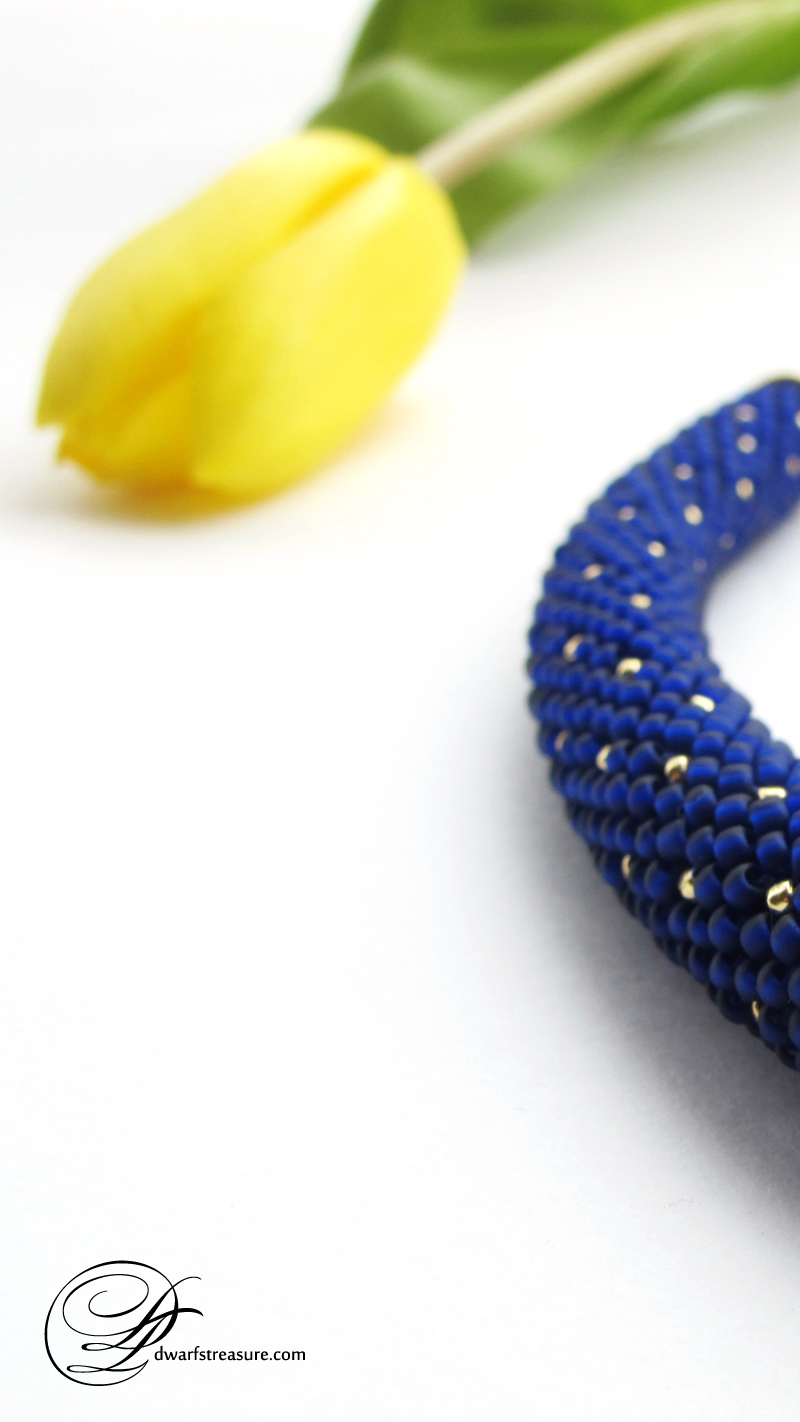 Fashionable navy blue beaded crochet custom made necklace with gold polka dot pattern