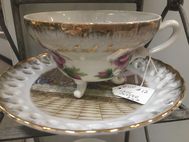 white, pink,  and gold tea cup and saucer