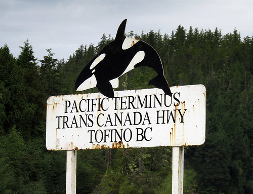 Sign topped by an Orca (Killer Whale) states that Tofino is the Pacific Terminus of the Trans Canada Hwy