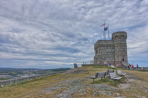 cabottower signalhill architecture stjohns gabih newfoundlandandlabrador clouds sky hill view tourists flags benches historical johncabot explorer gothicrevival castle fence overlook