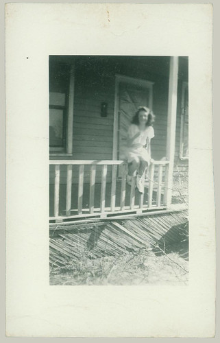 Girl on porch rail