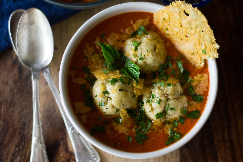 Roasted tomato soup with ricotta parmesan matzo balls is an Italian inspired twist for Passover matzo ball soup.