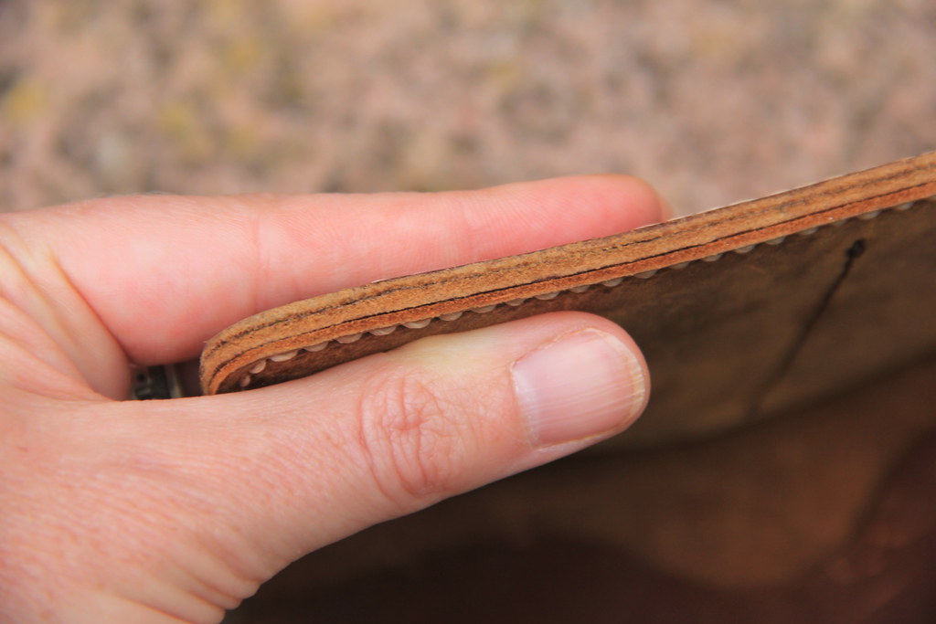 Demonstrating the thickness and quality of leather used to make the JooJoobs leather travel wallet