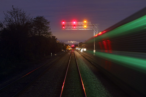metra commutertrain passengertrain dawn firstlight signals naperville illinois train railroad bilevel il night signalbridge track blur streak