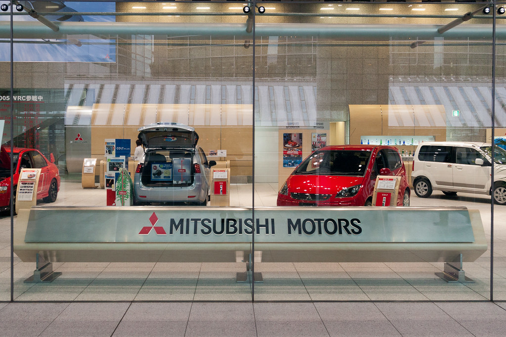 Mitsubishi cars on display in the middle of a tall building in Tokyo in 2005