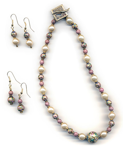 A necklace and earrings featuring the rose pink semi-precious stone Rhodonite along with glass pearls and gold cloisonné
