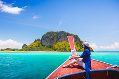 Happy female traveling on boat, Krabi Thailand