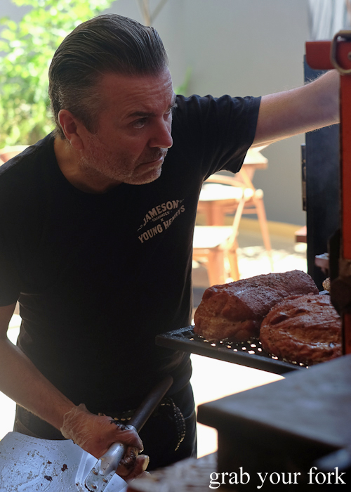 Pitt boss Anton Hughes checking the brisket at Hughes Barbecue at The George Hotel in Waterloo Sydney