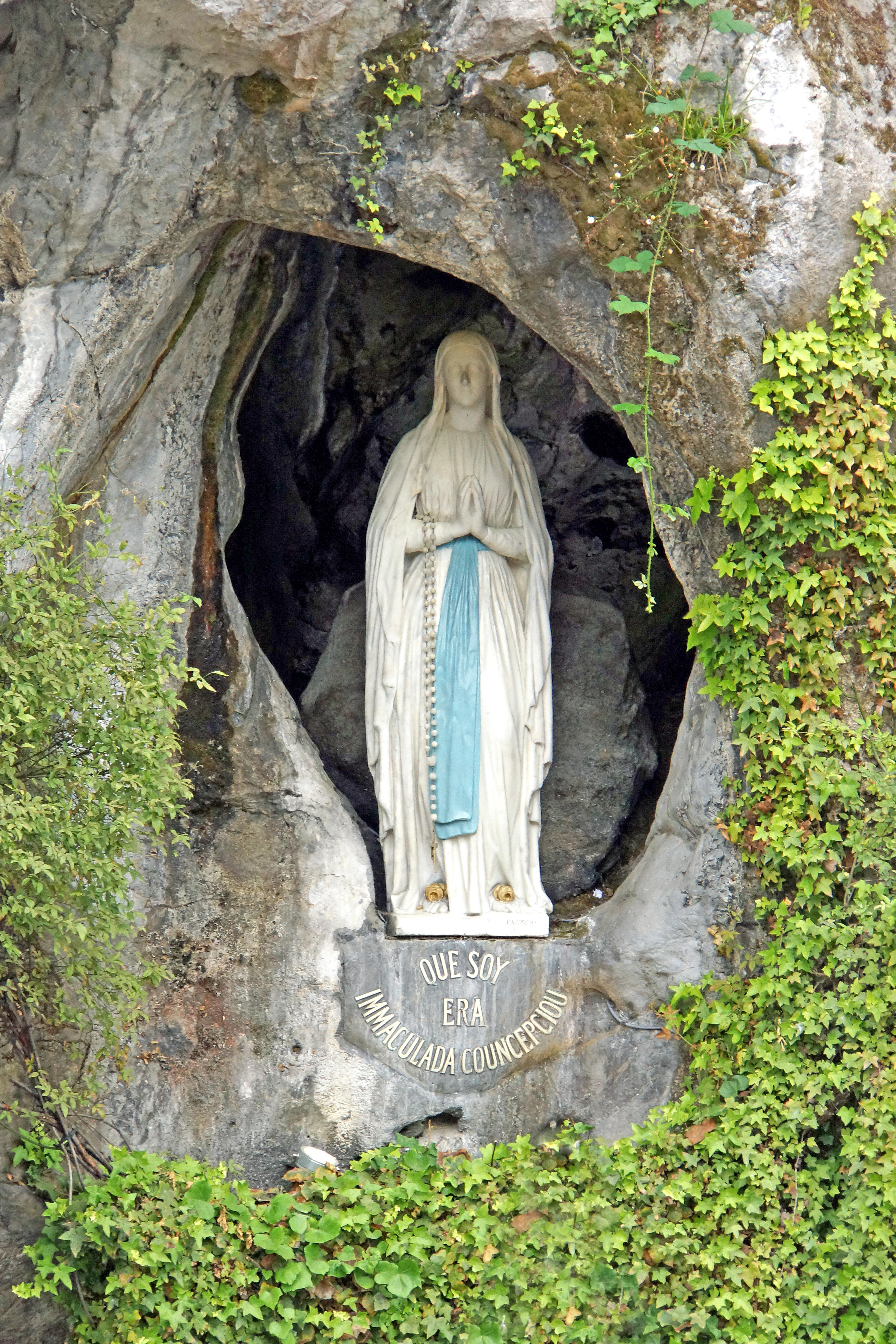 The statue within the rock cave at Massabielle in Lourdes, where Saint Bernadette Soubirous claimed to have witnessed the Blessed Virgin Mary, though however she disapproved of its artistic demeanor. Now a religious grotto. Photo taken on June 28, 2014.