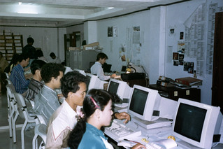 Entering voter registration information in the UNTAC Computer Center - Tom Riddle sihe desk against the front wall.