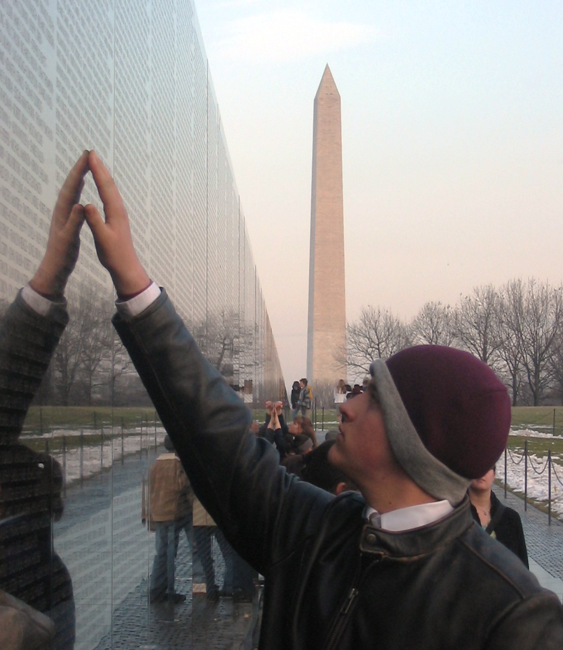 A visitor touching a name on The Wall at the Vietnam Veterans' Memorial. Photographed on January 26, 2005.