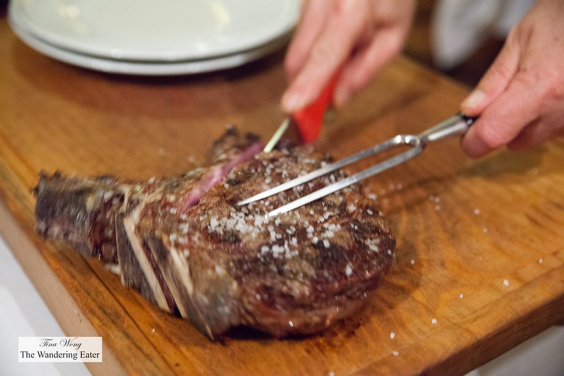 Our waiter slicing our steak