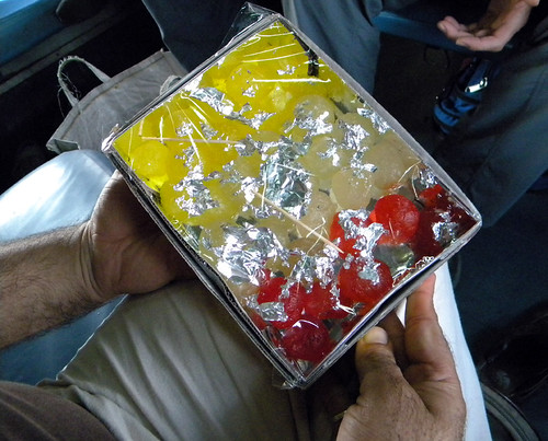 Our seat mates offer us candied squash treats on the train to Agra, India