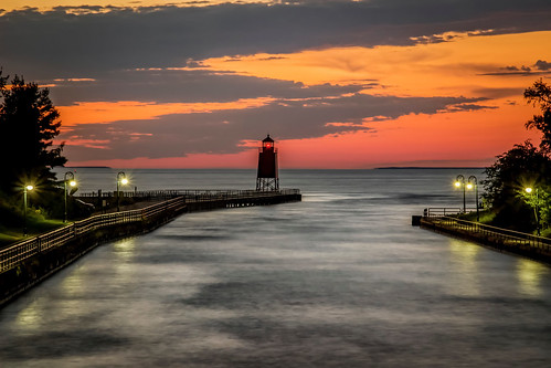 horizon pier lighthouse light sea lake sky sunset