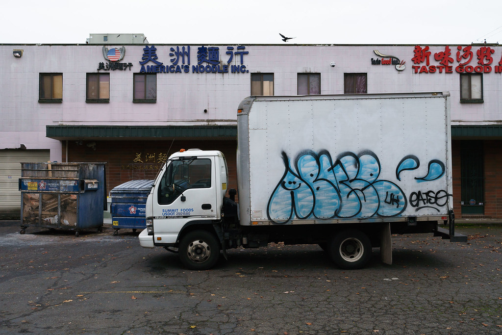 A graffiti-covered truck is parked outside America's Noodle in Portland's Irvington neighborhood