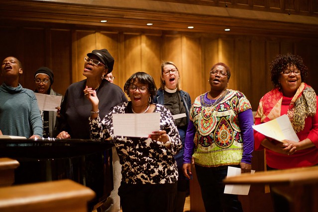 A group of women singing with enthusiasm on an altar.