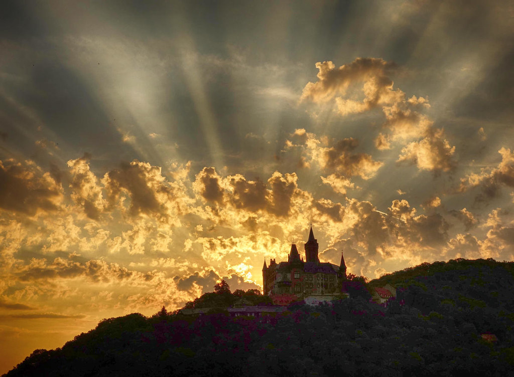Sun rising behind Wernigerode Castle. Credit Tillea
