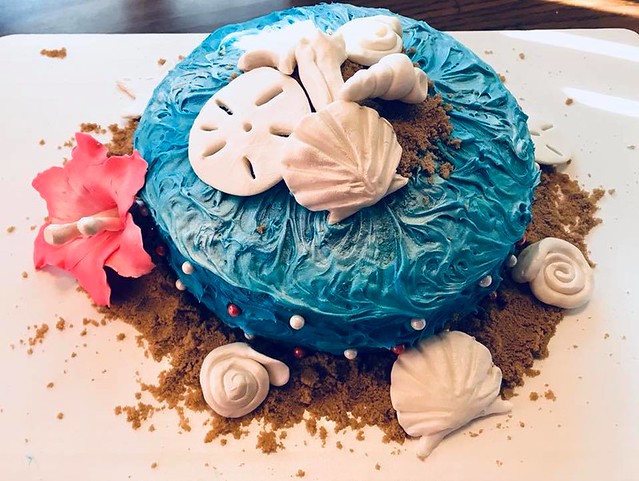 Hibiscus Paradise Cake by Tara Bowne. 7 different blues with handcrafted fondant flower and shells