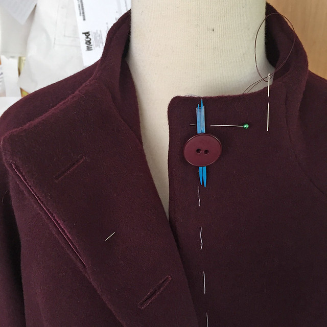 H coat sewing on buttons