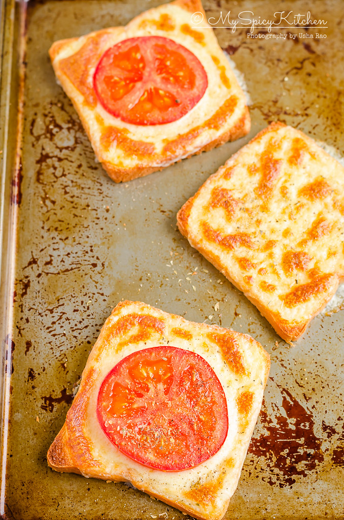 3 ingredient Tomato cheese toast on a baking sheet. 