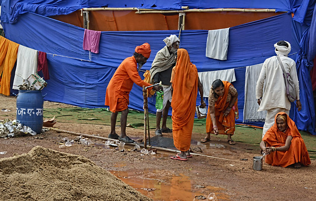 Participants drink water from the taps. The kumbh participants complain that the drinking water supplied to them was not safe and many fell sick after drinking it.