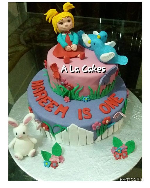 A 2 tier Garden themed Chocolate mint fudge cake, featuring hand crafted birds, doll and a cute bunny. By Bilquees Pirzada of A La Cakes