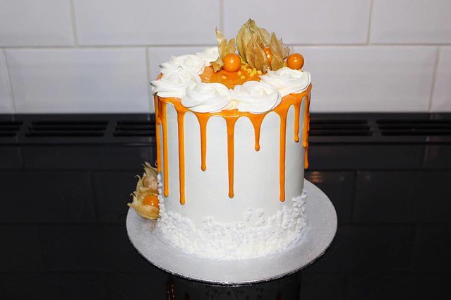 Mango & Passion-Fruit Cake with Coconut Buttercream, White Chocolate Ganache Drip and Physalis by Rodney’s
