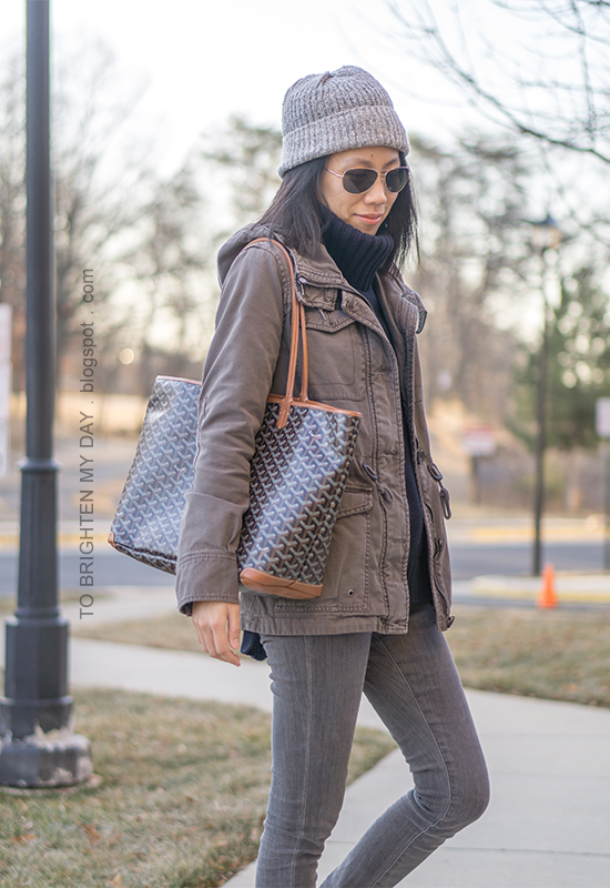 light gray beanie, gray military jacket, navy turtleneck tunic sweater, gray skinny jeans, printed tote