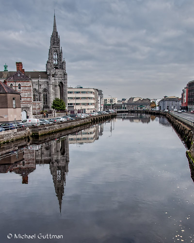 cork ireland riverlee holytrinitychurch capuchinfriary church cathedral gothic spire reflections river city cityscape water buildings cars automobiles sky clouds cloudyskies reflection nikon d90