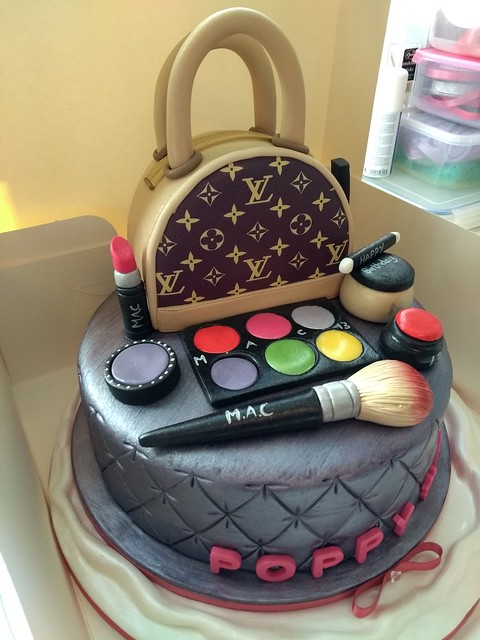 Salted caramel Louis Vuitton handbag cake, sat on a vanilla sponge with cushion effect and hand made make up prices by Vicky Blacktopp of Victoria's Cake House