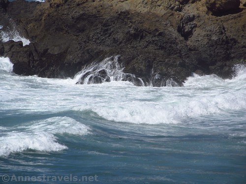 Waves crash on the cliffs below the trail north of Glass Beach, California