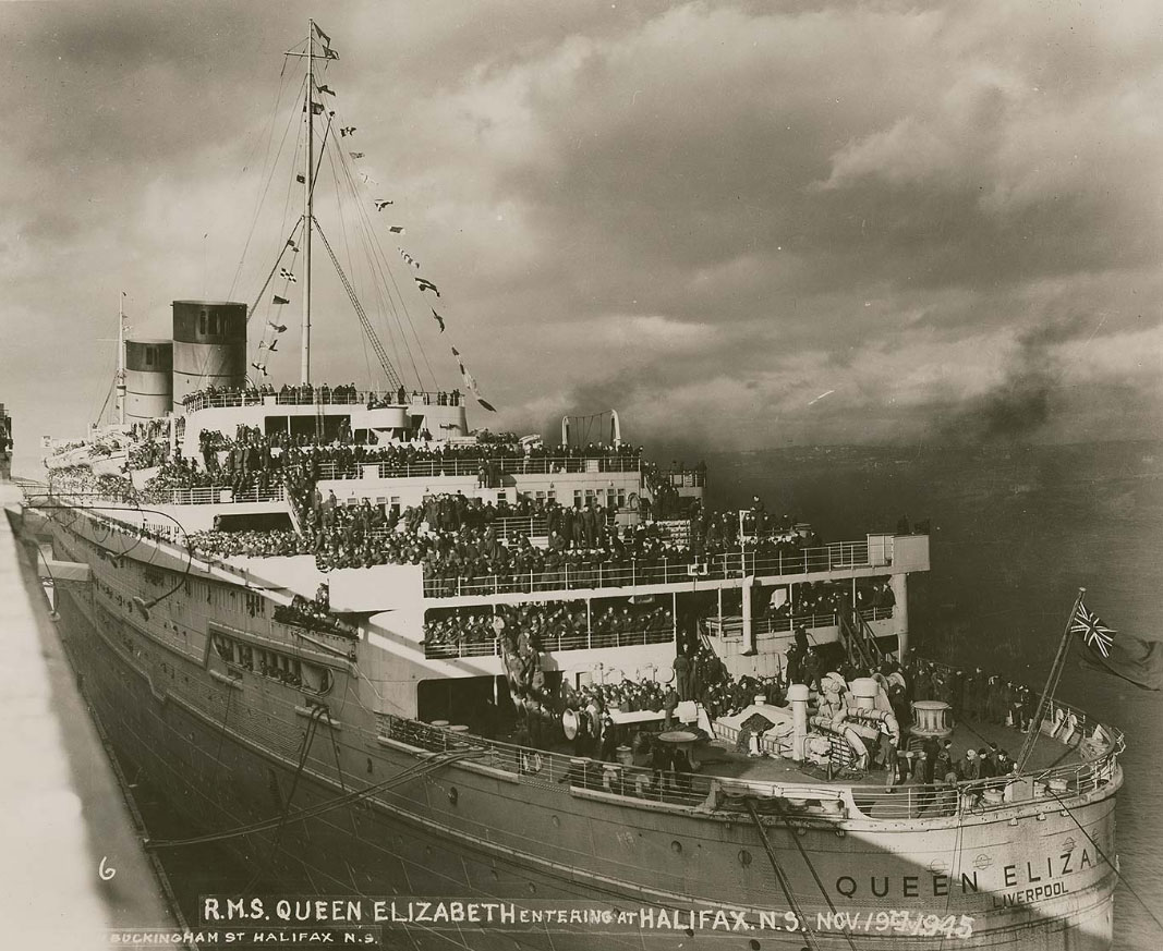 Queen Elizabeth moored in Halifax, Nova Scotia, bringing home returning troops following the end of World War II. Photo taken on November 19, 1945.