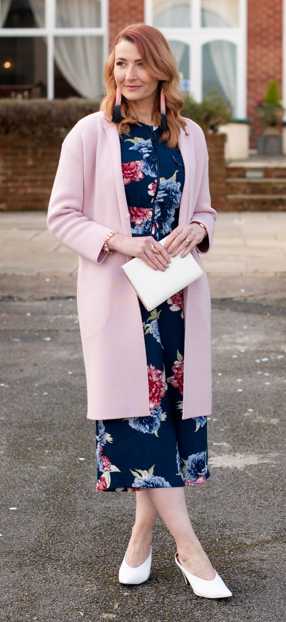 What to Wear to a Winter Wedding as a Wedding Guest - floral wide leg jumpsuit \ longline pink coatigan \ white pointed mules \ white clutch \ tassel earrings | Not Dressed As Lamb, over 40 style