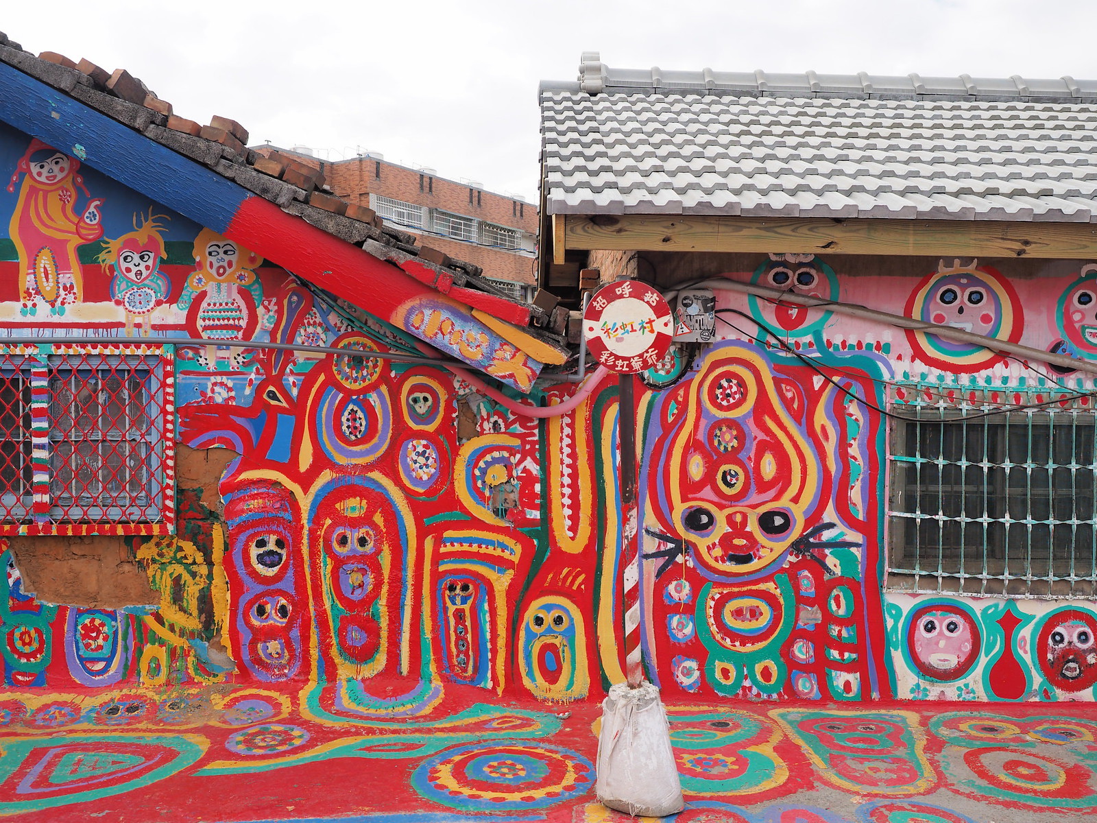 Colourful characters painted on the wall of the houses